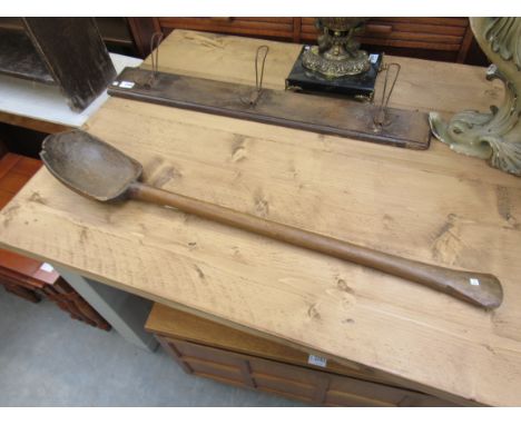 A large rustic timber ladle/spoon