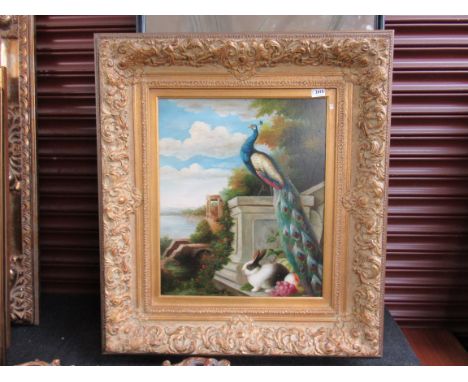 A modern gilt framed reproduction print depicting a peacock and rabbit 