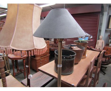 A brass finish standard lamp