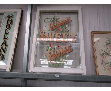 A painted "Home Sweet Home" sash window
