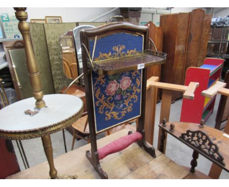 A 19th Century mahogany and brass screen of small proportions, the hinged shelf and tapestry rising panel over sledge feet 