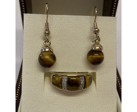 A 9ct gold tigers eye and diamond dress ring together with a pair of tigers eye drop earrings.  Ring set with 3 panels of tig