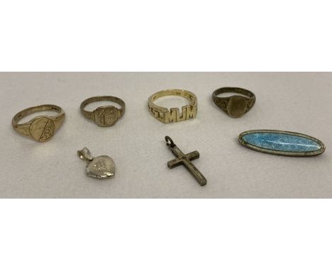 A small collection of silver jewellery.  Comprising: 3 signet style rings, 'MUM' ring, small heart shaped locket, cross penda