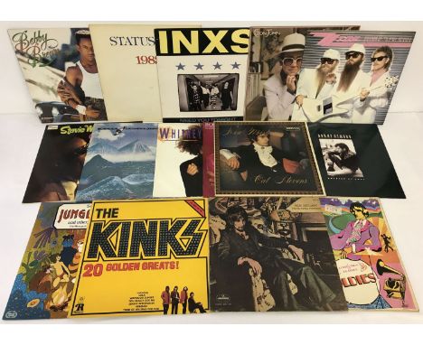  A collection of vintage vinyl LP and 12 inch records.  To include: ZZ Top, INXS, Rod Stewart, Elton John and Status Quo. 
