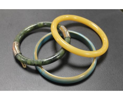 A SPINACH JADE TYPE BANGLE / BRACELET, WITH WHITE METAL FASTENER, together with two other bangles (3)