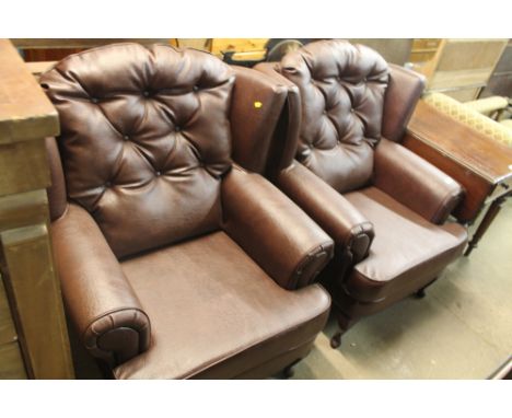 A PAIR OF BROWN FAUX LEATHER BUTTON BACK ARM CHAIRS 