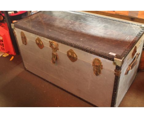 A LARGE METAL TRAVEL TRUNK