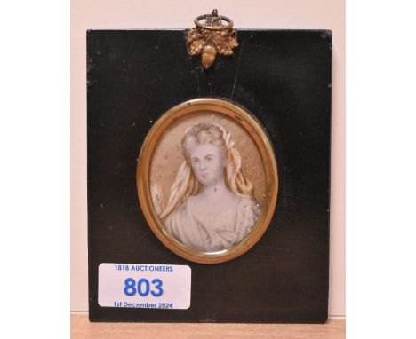 19th Century School, a portrait miniature of a woman with white headdress, set within an ebonised frame with gilt mount and g