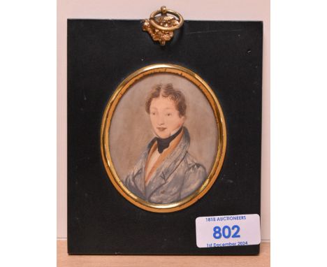 19th Century School, a portrait miniature of a young gentleman wearing a blue overcoat, set within an ebonised frame, within 