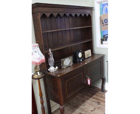 Edwardian oak and chequer inlaid dresser, the shelf back above two cupboard doors on cabriole legs, 189cm by 143cm by 45cm.