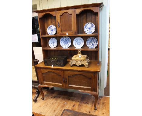 Art &amp; Crafts oak dresser, the shelf back having arched panelled cupboard door above a base of two arched panelled cupboar