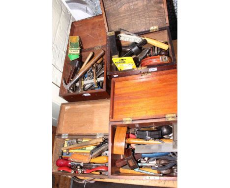 Four small boxes of tools including spoke shaves, planes, measures, gauges, etc.