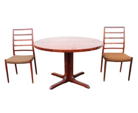 NIELS MOLLER (DANISH, 1920-1982), a set of eight rosewood ladder back chairs, 94cm high, together with an extending dining ta