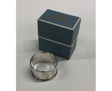 An engine turned silver napkin ring. Birmingham. Approx. 15 grams. Est. £10 - £20.