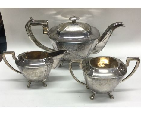 A fine quality Chinese silver three piece tea service attractively decorated with dragons. Punched to base. Approx. 1033 gram