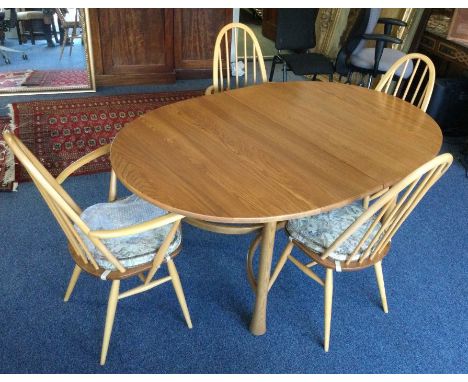 ERCOL: A good dining table together with leaf of shaped form with four matching chairs. Est. £200 - £300.