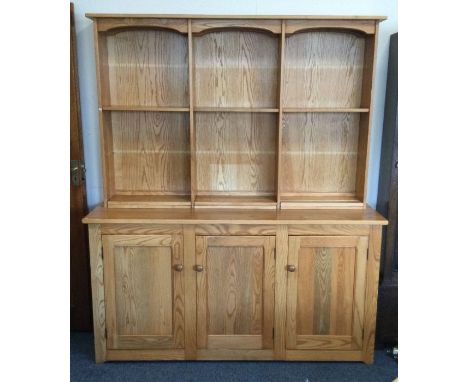 ERCOL: A good elm three drawer dresser with fitted interior. Est. £100 - £150.