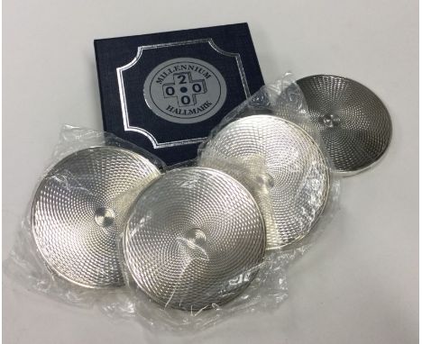 A good set of four engine turned commemorative silver Millennium coasters contained within original case. Est. £100 - £150.