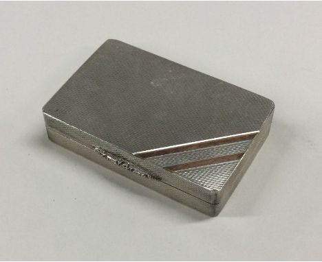 A heavy engine turned silver pill box with gold inlaid decoration. London. By Asprey &amp; Co. Approx. 84 grams. Est. £80 - £