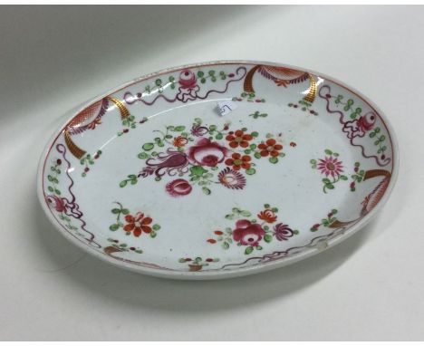 An oval Antique teapot stand decorated with bight flowers. Est. £20 - £30.