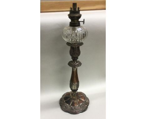 An Old Sheffield Plated oil lamp with glass reservoir. Est. £30 - £50.