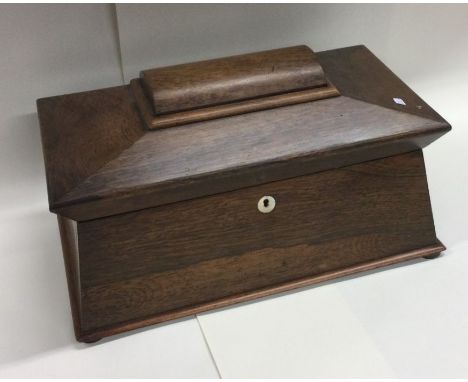 A large rosewood tea caddy of shaped form to hinged lid. Est. £60 - £80.