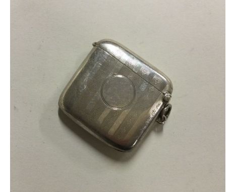 A large engine turned hinged top silver vesta case. Birmingham. by JH. Approx. 28 grams. Est. £20 - £30.
