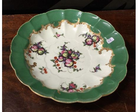 An early Worcester dish decorated with fruits to gilt border. Est. £70 - £80.