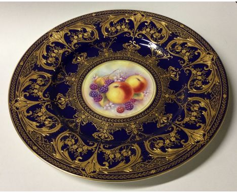 A Royal Worcester decorative gilded plate signed M Moran. Est. £30 - £50. 