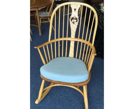 ERCOL: A slat back rocking chair. Est. £50 - £80.