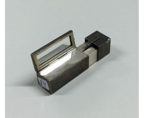 An unusual engine turned silver lipstick holder. Approx. 50 grams. Est. £20 - £30.