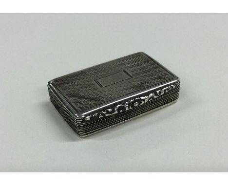 A rectangular engine turned silver snuff box with cast rim to gilt interior. Birmingham. By Francis Clarke. Approx. 38 grams.