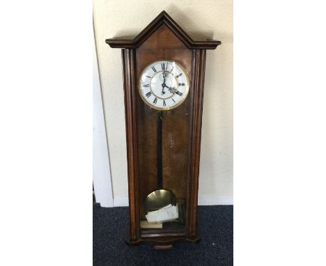 A good Edwardian wall clock with white enamelled dial. Est. £20 - £30.