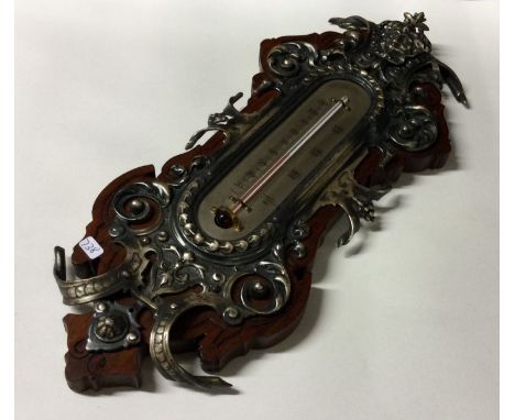 A large mahogany and silver plated barometer with embossed decoration. Est. £25 - £30.