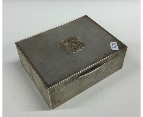 A heavy engine turned silver cigar box, the solid lid with gold inlay. Chester. By Asprey &amp; Co. Approx. 437 grams. Est. £