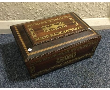 A good rosewood and brass inlaid tea caddy. Est. £100 - £150.