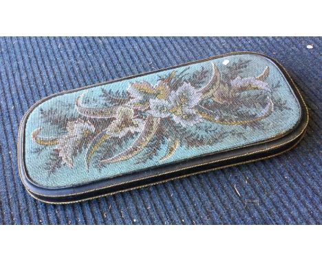 A tapestry mounted clock stand with brass beadwork border. Est. £20 - £30.