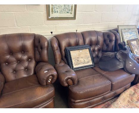 A modern leather button backed living room suite of sofa and two armchairs