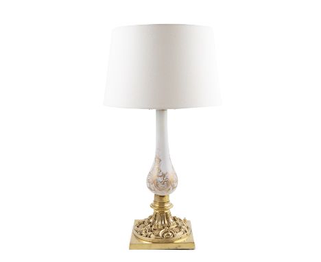 A cast brass and milk glass table lamp, the circular baluster column with gilded decoration, on a circular cast pedestal foot