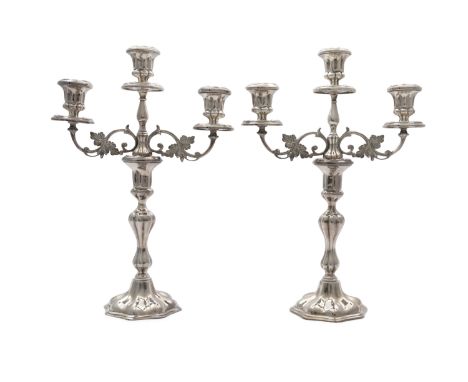 A pair of Irish silver cast table candelabra, mark of Royal Irish Ltd., Dublin 1971, with detachable three light sconces with