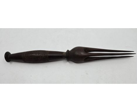 A carved wooden Fiji Island Ceremonial or Cannibal Fork. 19th Century. A barrel form grip carved with panels of zig-zag and l