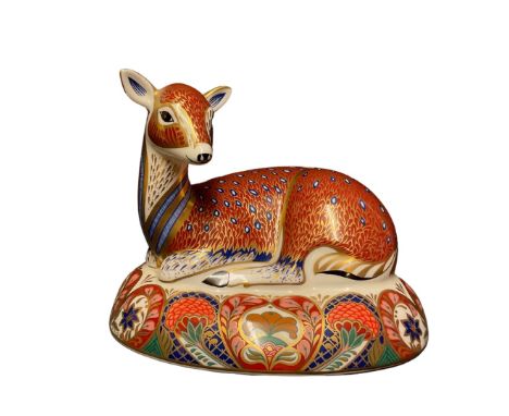A Royal Crown Derby paperweight, recumbent deer, designed for Derby Collector's Guild. 16cm wide
