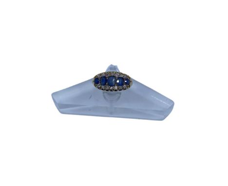Unmarked Yellow Metal (Possibly 18ct Gold?) Sapphire and Diamond Ring  The ring contains three Oval Brilliant Cut Sapphires a