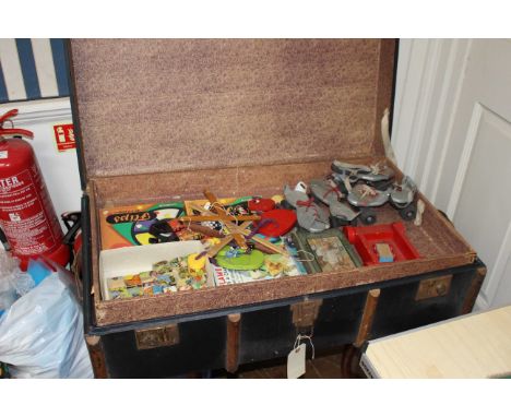 A large steamer trunk to include a varied selection of vintage childhood books, toys and games.