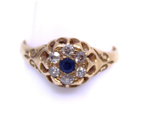 18ct Yellow Gold Sapphire and Diamond Flower Cluster Ring  The Ring is hallmarked "18CT" for 18ct Gold.  The Ring contains a 