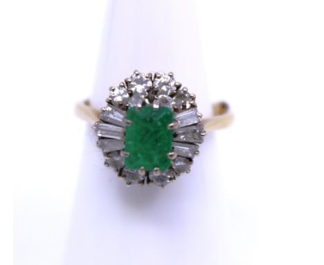 18ct Gold Emerald and Diamond Ring. The Emerald measures approx. 6.67mm x 4.93mm.  There is ten Round Brilliant Cut Diamonds 