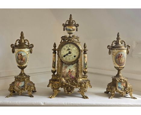 A Franz Hermle 18th century style gilt brass mantle clock and two garnitures with painted ceramic mounts. With key.