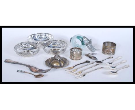 A collection of vintage silver plated and plated wares to include napkin rings, spoons, pin dishes, pickle fork etc.