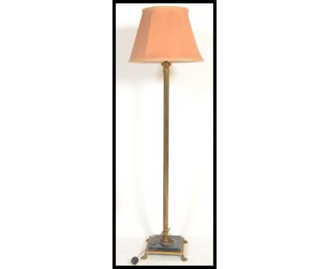 A vintage early 20th century Antique style marble and brass floor standing lamp raised on paw feet with square base with cent