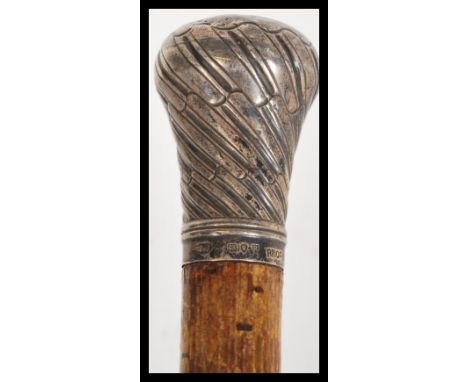 A 19th Century silver hallmarked walking stick cane having a tapering wooden shaft with silver pommel top. Retailed by Brigg 